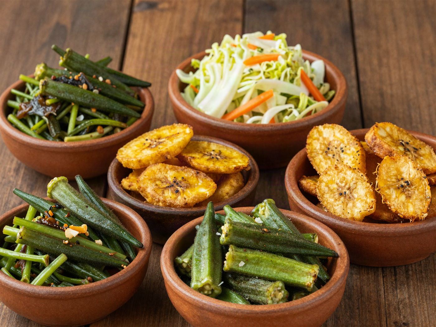 Colourful Trinidadian vegetable sides in rustic bowls
